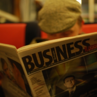 A man reading a business journal.Business news spreads daily through the business journals, newspapers, and magazines.